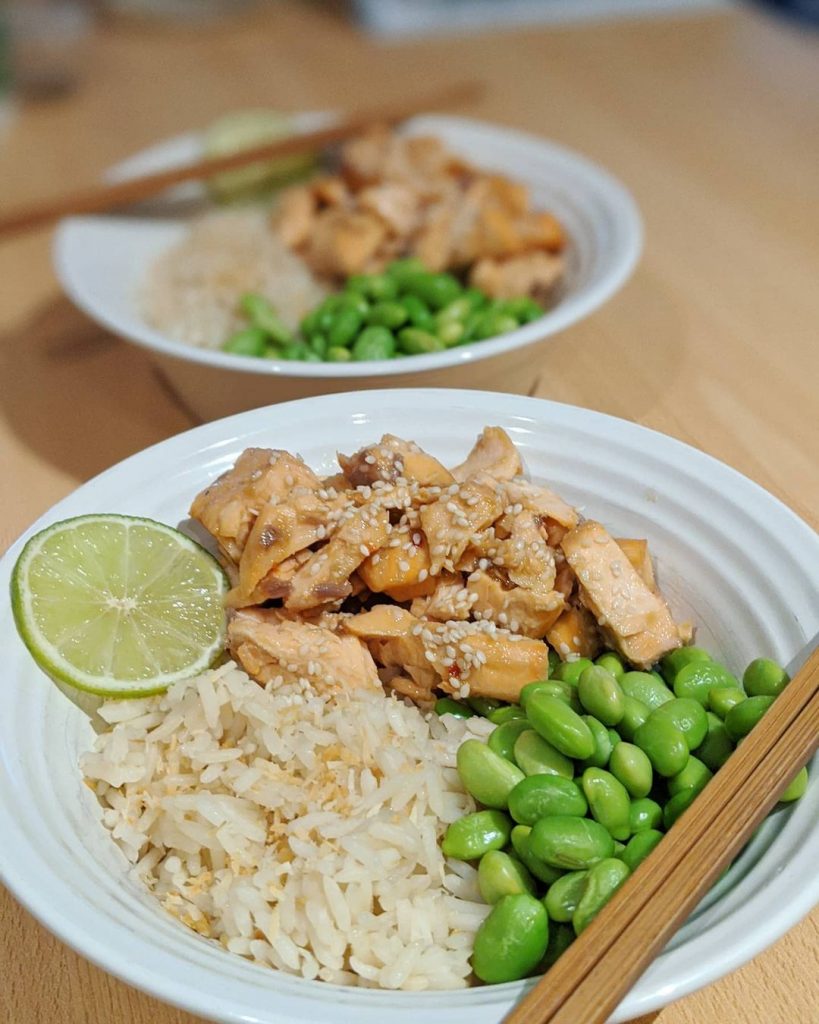 A bowl of salmon, rice and edamame