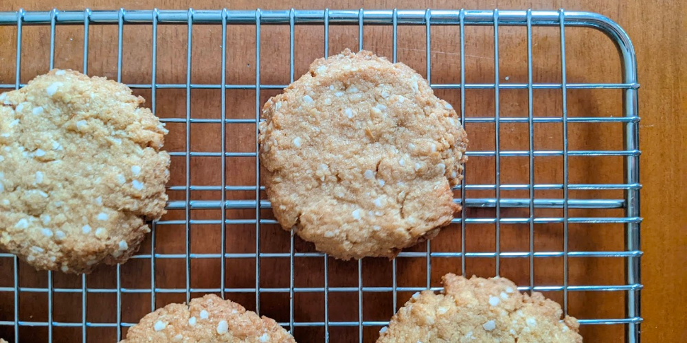 Oat free gluten free ANZAC biscuits cooling on a wire rack.