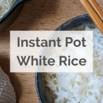 Cooked white rice in a bowl with chopsticks
