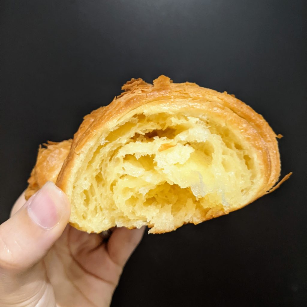Croissant cross section showing pastry layers.