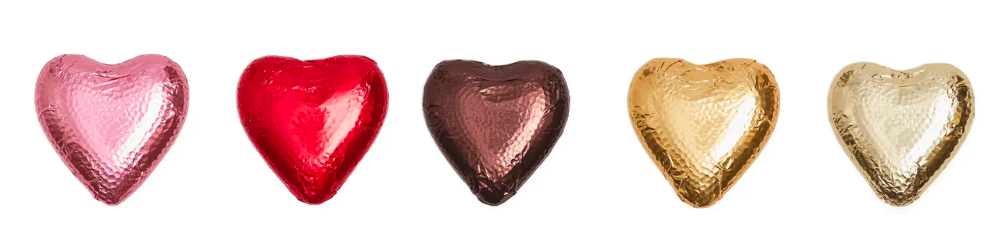 Gluten free chocolate hearts by haighs. Picture shows different gift wrap colours: pink, red, brown, gold and light gold. 