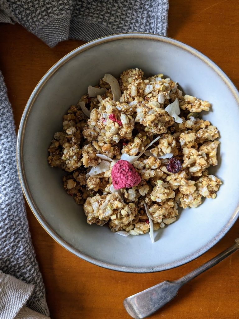Coles clusters cereal in a bowl, freeze dried raspberry and cranberries are visible. 