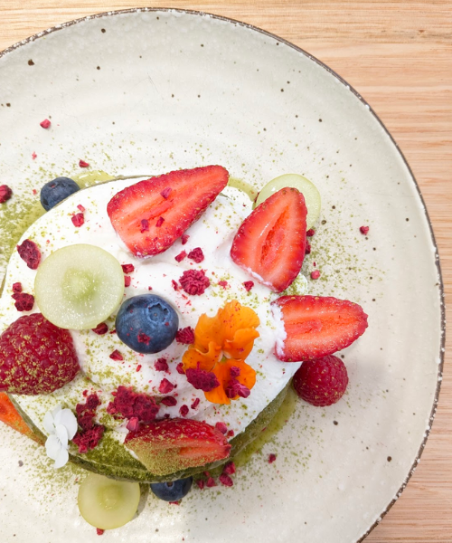 Matcha hotcakes by noglu essendon topped with ganache and fresh fruits.