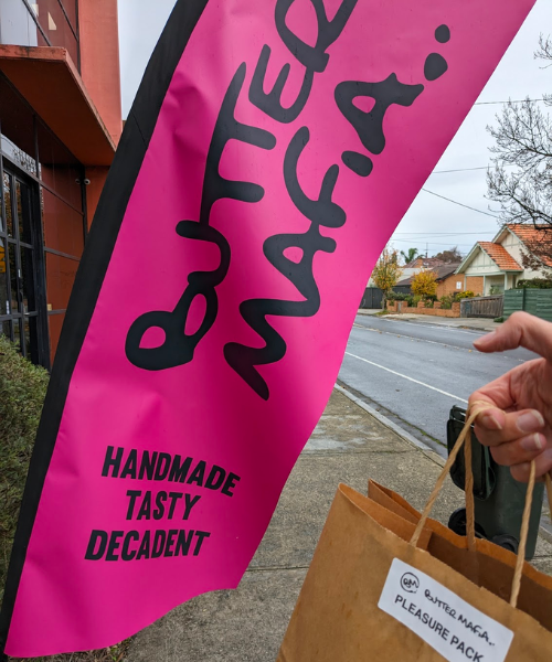 A hot pink flag style sign saying Butter Mafia