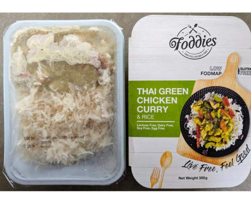 The packaging for Foddies Thai green curry beside the meal tray showing the rice and curry. 