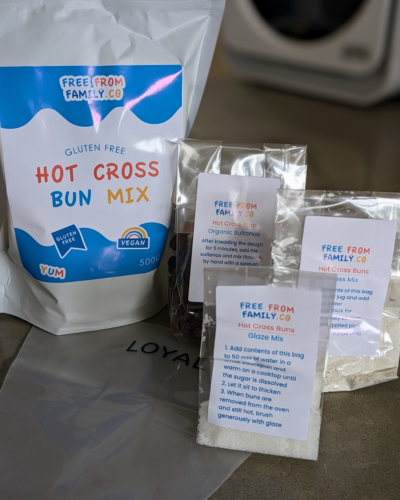 One large bag labelled hot cross bun mix with three small clear bags containing baking ingredients.