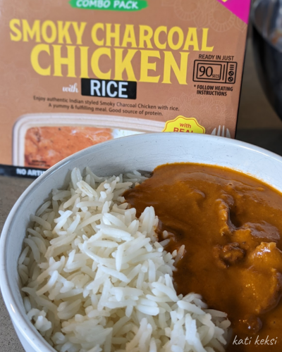 A bowl of rice and curry. Coco earth packaging in the background.