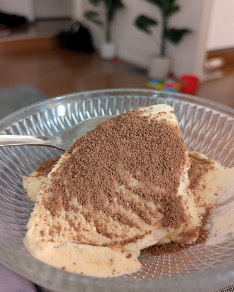 A bowl of ice cream with chocorama powder on it