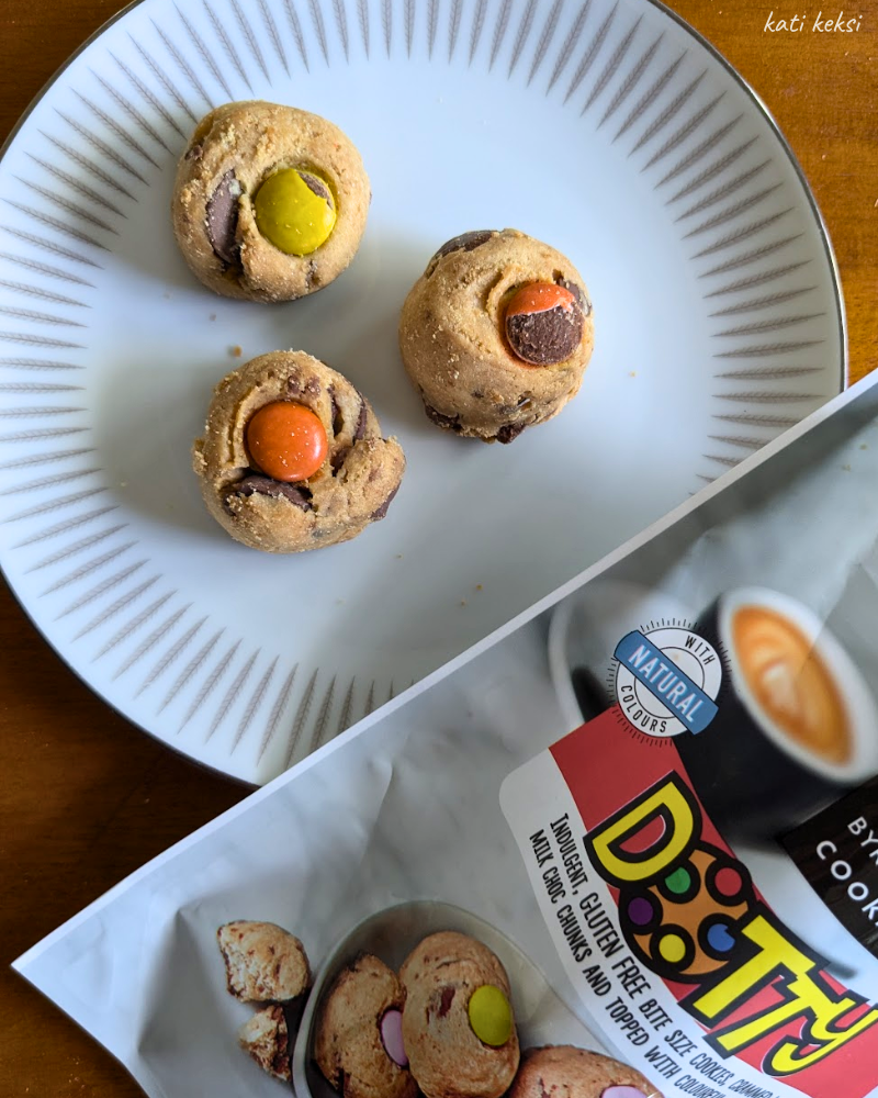 Three dotty gluten free cookies sitting on a white plate.