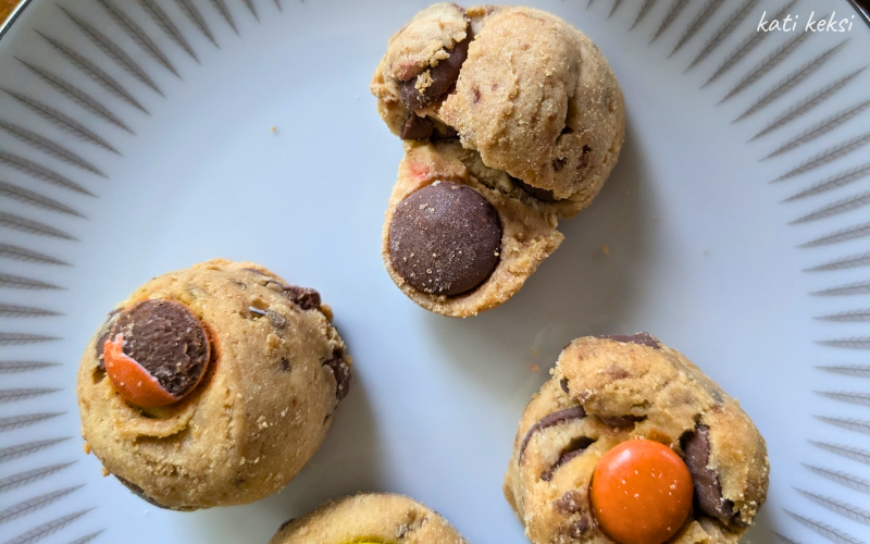 Three cookies on a plate. Two are round the other looks to have been pressed out of shape.