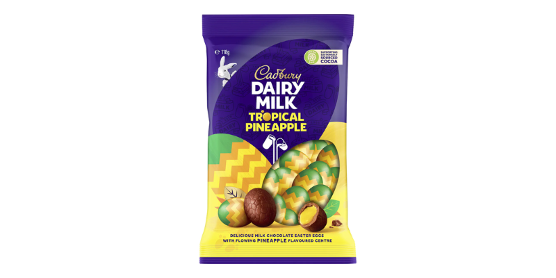 A packet of Cadbury pineapple mini eggs showing a bright yellow cream centre.