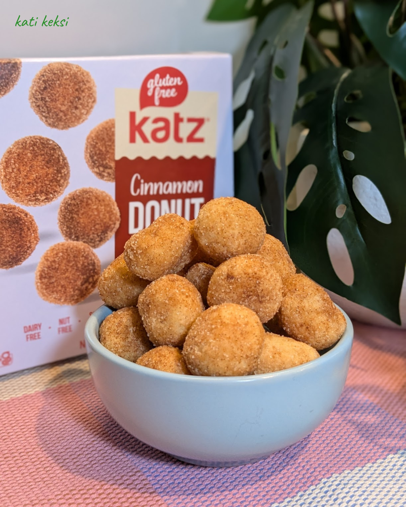 A bowl of donut holes with a box in the background reading Katz